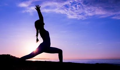 Selbstklebende Fototapeten Entspannung girl doing sport on the beach  © Sergio