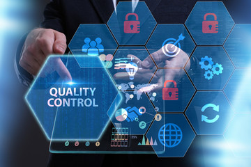 Business, Technology, Internet and network concept. Young businessman working on a virtual screen of the future and sees the inscription: Quality control