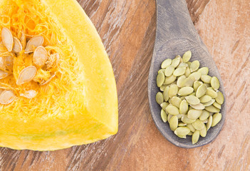 Pumpkin seeds on the wooden background