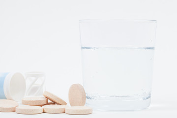 Fizzy tablet with packaging and glass of bubbling water