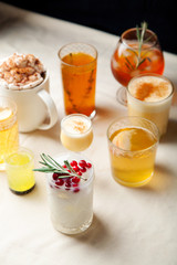 Set of various winter cocktails: mulled wine, eggnog, limoncello, old-fashioned, coconut margarita.