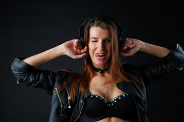 Picture ofyoung girl in headphones at leather jacket