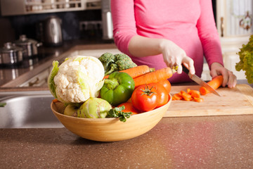 Pregnant woman is cooking