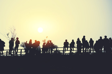 asians travel relax in the holiday.People stand looking at the sun in the morning. Stand up for sunrise on the Moutain