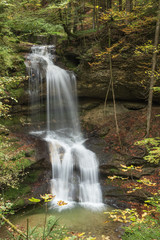 Fototapeta premium Looking at the two stages of the Hasenreuter waterfall in the forest near Scheidegg