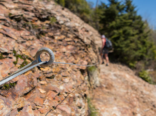 Safety Wire Strung Along Rocky Trail With Hiker