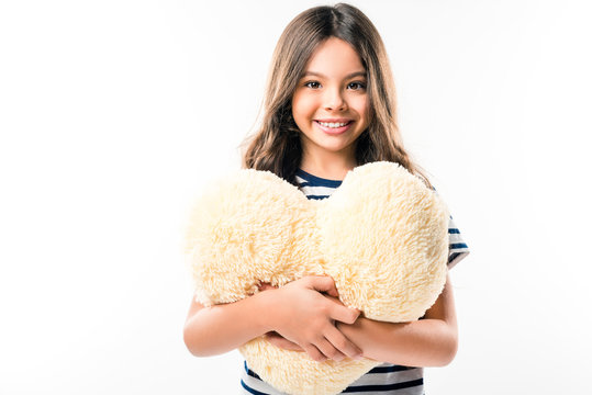 Child Holding Heart Shaped Pillow