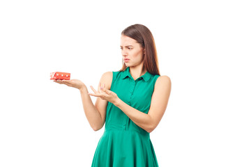 Studio portrait of beautiful young woman holding small gift box on white background