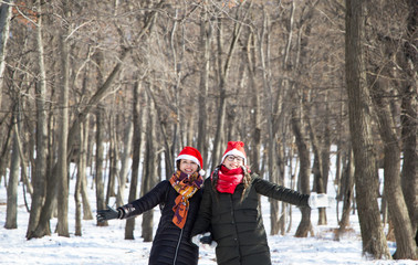 two santa girls in the forest