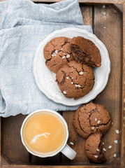 The perfect tasty breakfast!) Chocolate chip cookies with dark chocolate and sea pink Himalayan salt and cup of coffee on a gray concrete background. Best Brown Butter Cookies. 