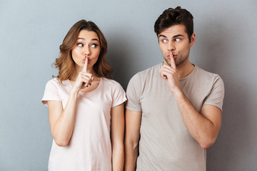 Portrait of a young couple showing peace gesture