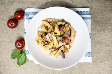 Pasta with pesto sauce and nuts on a the table