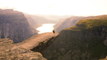 Sitting on the edge of Trolltunga in Norway.