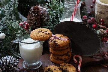 Chocolate chip cookies milk and letter for Santa on festive Xmas background