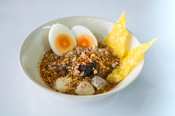 Spicy noodle with eggs and crispy wonton.