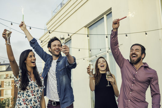 Friends Celebrating With Champagne Outdoors