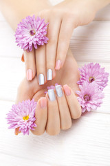 pink manicure with chrysanthemum flowers. spa