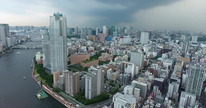 TOKYO, JAPAN – JUNE 2016 : Aerial shot of central Tokyo cityscape with tall buildings and river in view