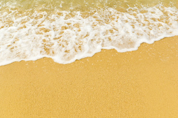 Fototapeta na wymiar Sand beach and wave on sunny day