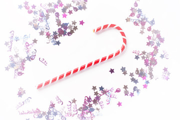 Christmas or New year festive background. Greeting card composition with striped candy and glitters. Holidays concept.