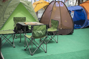 Tent Camping with desk and chairs in pine forest