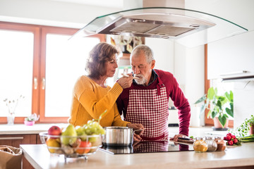 Senior couple preparing food in the kitchen.