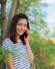 Portrait of asian girl talking on telephone