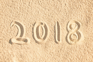 2018 written in the sand of a beach, new year travel concept