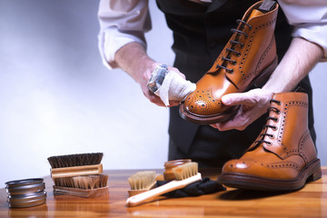 The process of cleaning shoes. A man is cleaning his shoes.