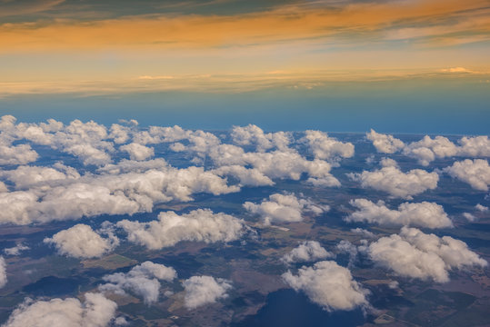 A view from a height to the ground and clouds above it. Sunny is a beautiful day © Ann Stryzhekin