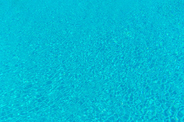 Fototapeta na wymiar The smooth water in the pool as a background