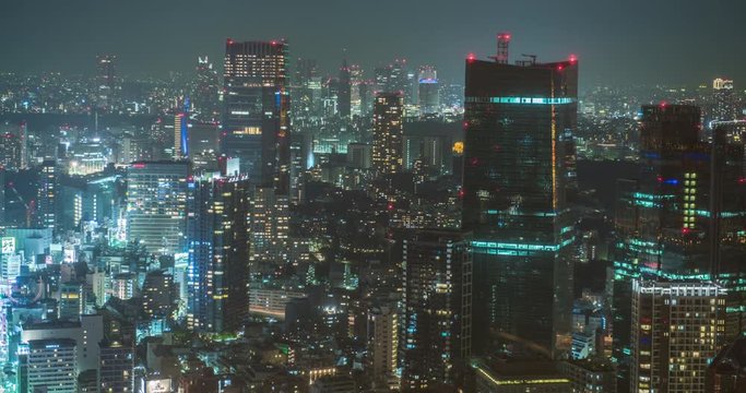 TOKYO, JAPAN – JUNE 2016 : Timelapse of central Tokyo cityscape at night with tall buildings in view, shot from Tokyo Tower