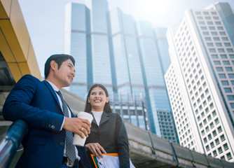 Happy Business colleagues talk outside office & talking to each other. Businessman talk and hold...