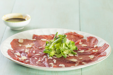 Carpaccio with a blue background