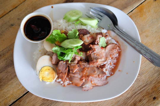 Barbecued red pork in sauce with rice and boiled egg, Thai Food