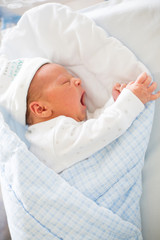 Newborn baby laying in crib in prenatal hospital © Tomsickova