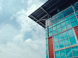 high and modern building with reflection of beautiful sky with cloud on glass