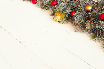Christmas fir tree with christmas decoration on a white wooden board