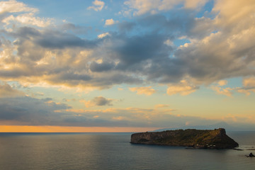 Isola di dino, italia, al tramonto. Colori, mare , cielo con nuvole in background. Raggi di luce del sole sul mare. Dino island in italy at sunset with beautiful colors , sunshine and sky with clouds