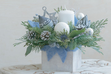 Pine Christmas floral arrangement in white wooden container