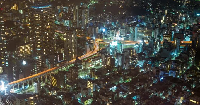 TOKYO, JAPAN – JUNE 2016 : Timelapse of central Tokyo cityscape at night with tall buildings and traffic in view, shot from Tokyo Tower