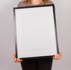 Woman's holding a blank picture frame