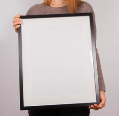 Woman's holding a blank picture frame