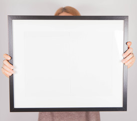 Woman's holding a blank picture frame