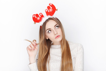 Beautiful emotional blonde female model wear santa deer headpiece. Christmas greetings concept.