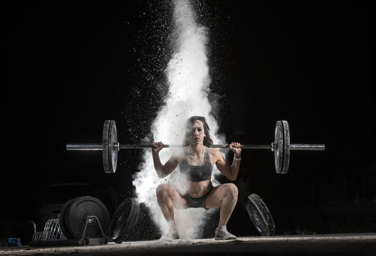 Woman Holding a Weight in the Gym