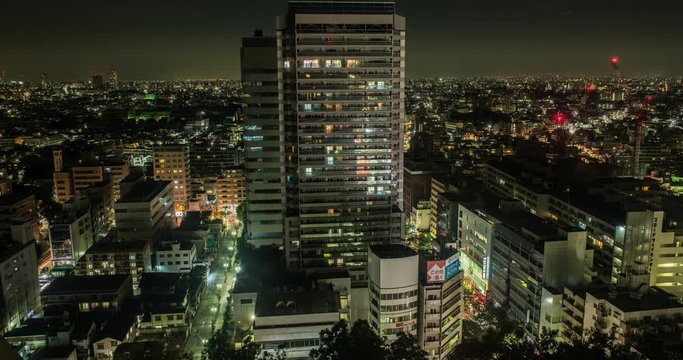 TOKYO, JAPAN – JUNE 2016 : Timelapse of central Tokyo cityscape with tall building in view at sunrise, night to day transition
