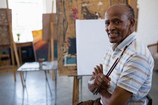 Portrait Of Smiling Senior Man With Arms Crossed