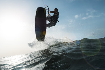 Surfer jumping a wave in front of the camera © Raul Mellado
