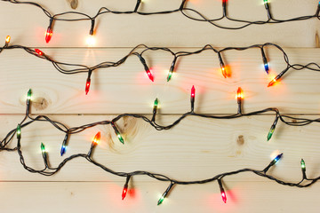 christmas lights on wooden background.